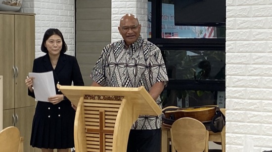 A person and person standing at a podium