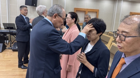 A person touching a person's forehead