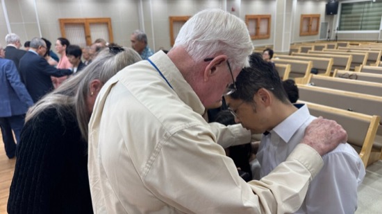 A person touching a person's forehead