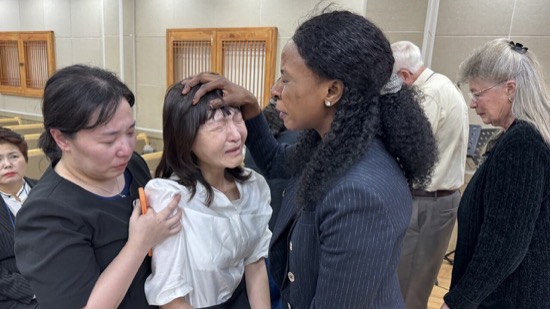 A person touching her forehead with her hand