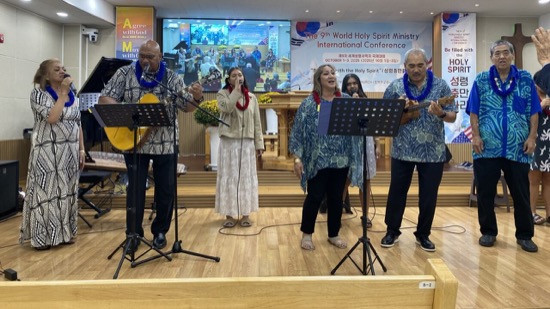 A group of people singing on a stage