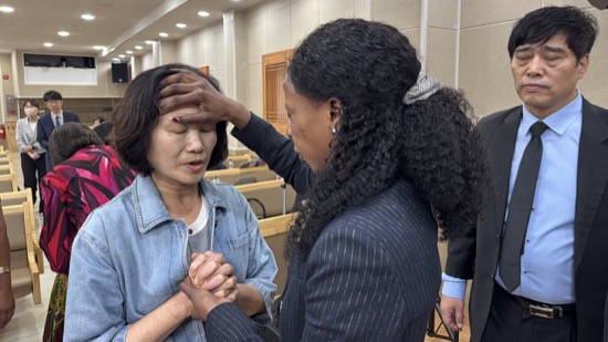 A person holding a person's forehead