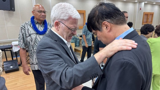 A person touching another person's shoulder