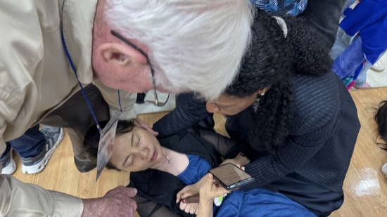 A person looking at a person lying on the floor