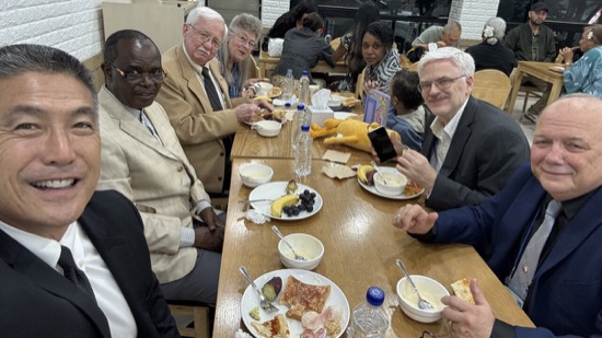 A group of people sitting around a table eating food