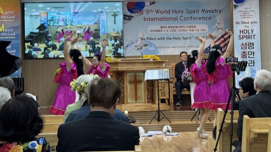 A group of women performing in front of a group of people