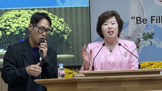 A person and person speaking into microphones