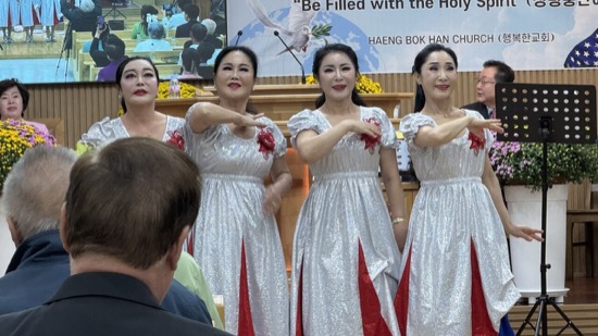 A group of women in white dresses
