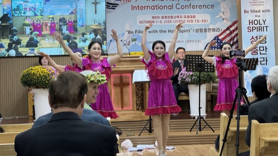 A group of women in pink dresses dancing