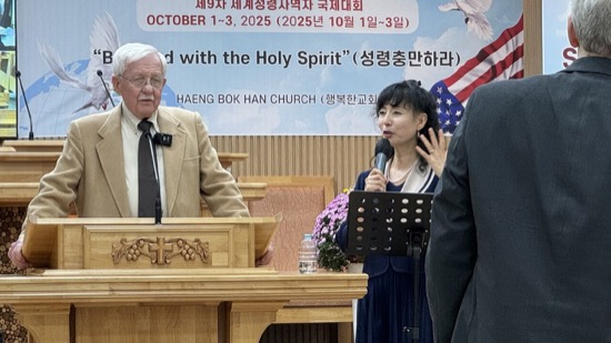 A person standing at a podium with a microphone