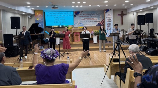 A group of people singing in a room