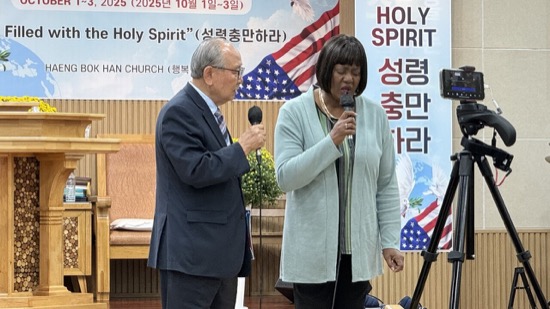 A person and person standing in front of microphones