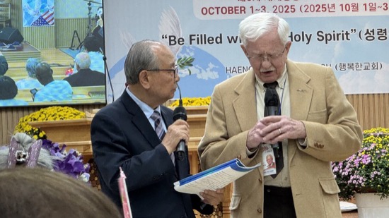 A person holding a microphone and talking to another person