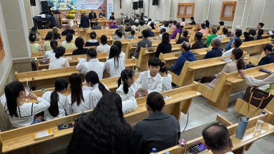 A group of people sitting in a church