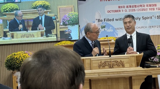 A group of men sitting at a podium