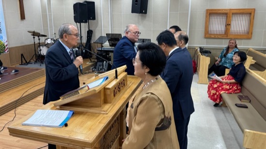 A group of people standing around a podium