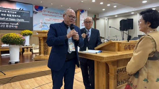 A person in a suit speaking into a microphone