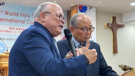 Two men in suits giving a thumbs up