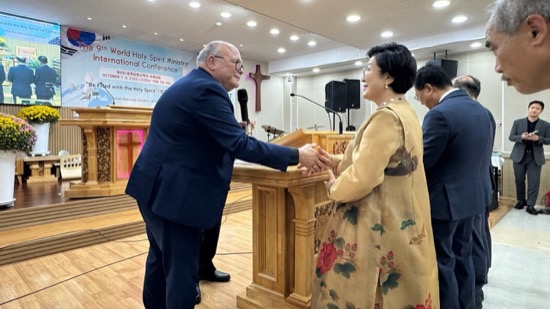 A person and person shaking hands
