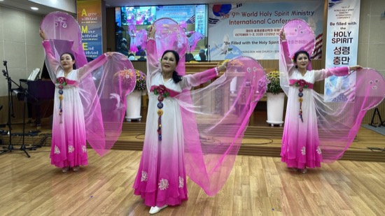A group of women wearing pink and white dresses