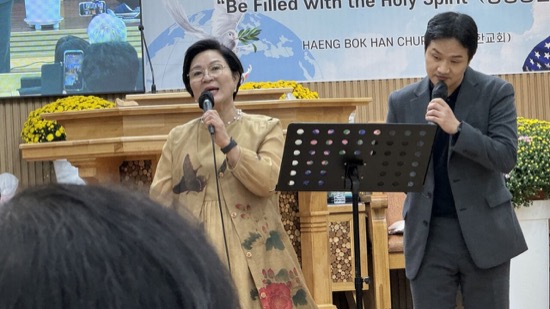 A person singing into microphones