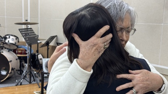 A person hugging another person