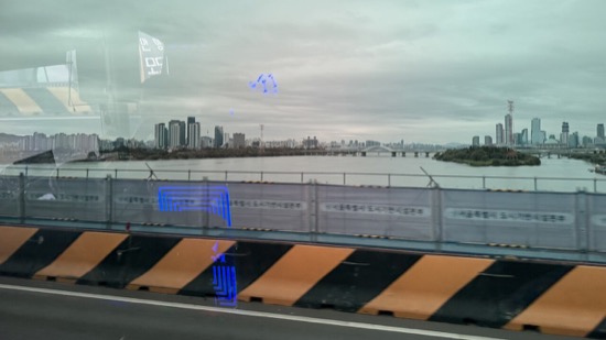 A bridge over water with a city in the background