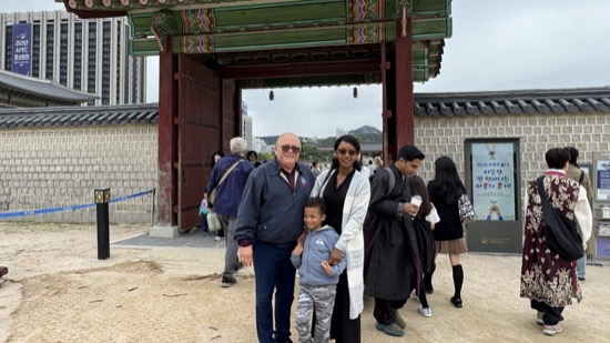 A group of people standing in front of a gate