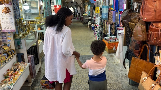 A person and child holding hands in a store
