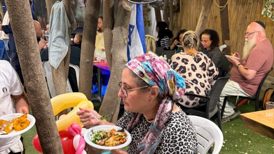 A person eating food at a table