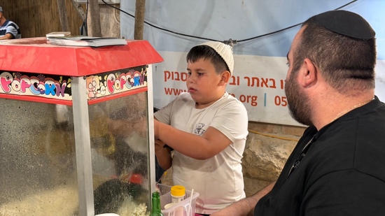 A child standing at a food stand