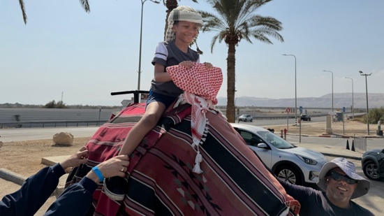 A person on top of a camel