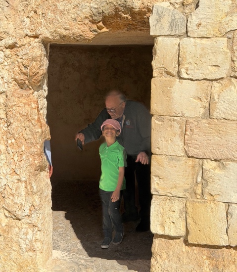 A person and a child standing in a doorway