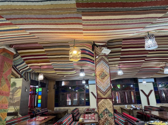 A colorful striped ceiling with lamps from the ceiling