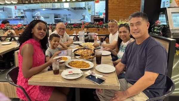 A group of people sitting at a table with food