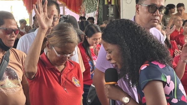 A person speaking into a microphone