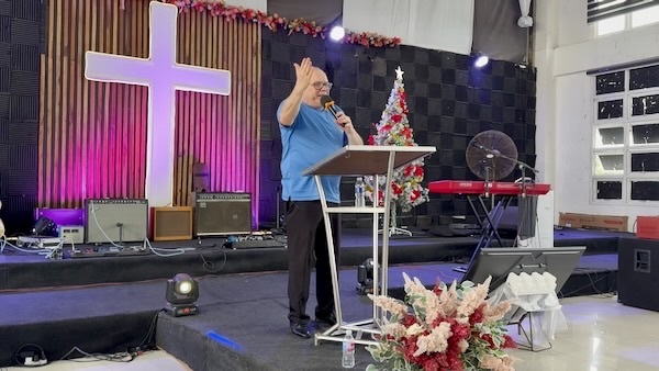 A person standing on a podium with a microphone