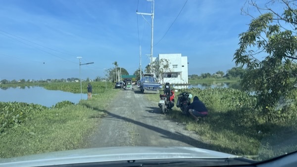 A road with cars and people on it