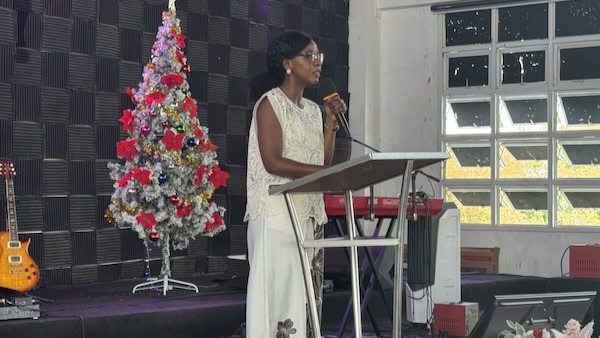 A person standing at a podium with a microphone