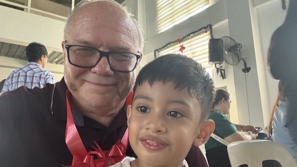 A person and child posing for a selfie