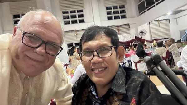 A person taking a selfie with another person