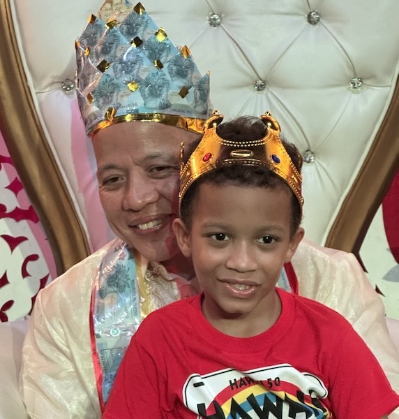A person and child wearing crowns