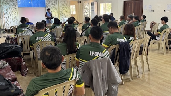 A group of people sitting in chairs