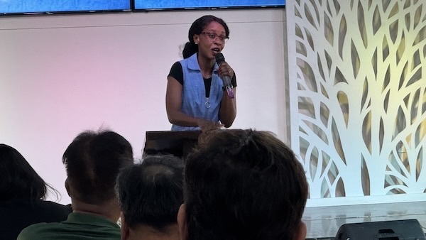 A person speaking into a microphone