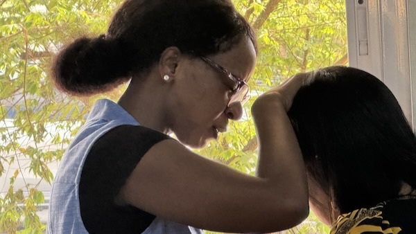 A person touching a person's head