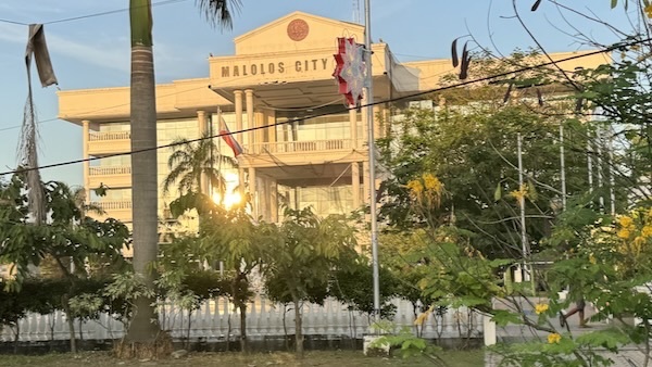 A building with trees and a flag