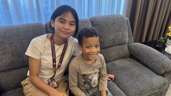 A person and a child sitting on a couch