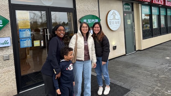 A group of women standing outside a building