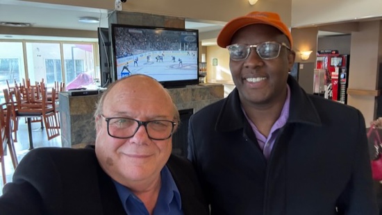 Two men smiling at the camera