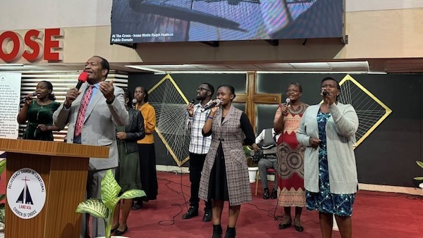 A group of people singing in a room